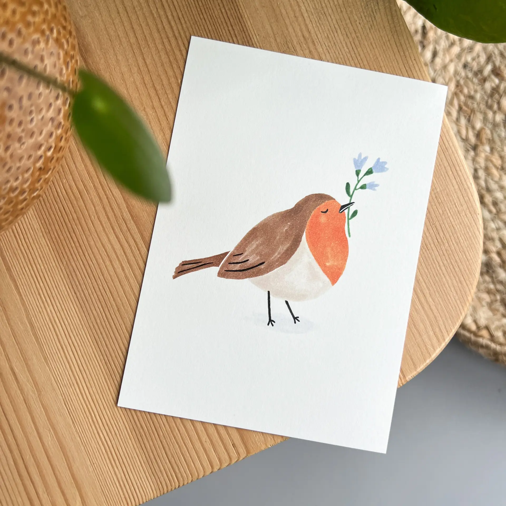 Kaartje met roodborstje en bloemetje
